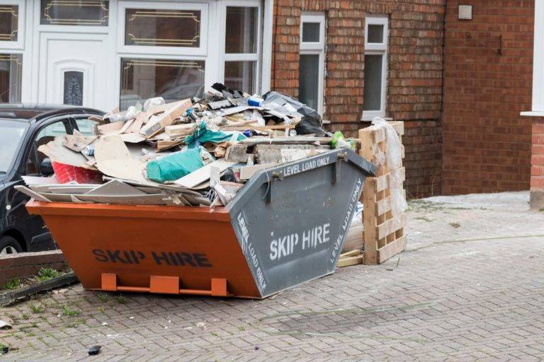 Overfilled skip outside house